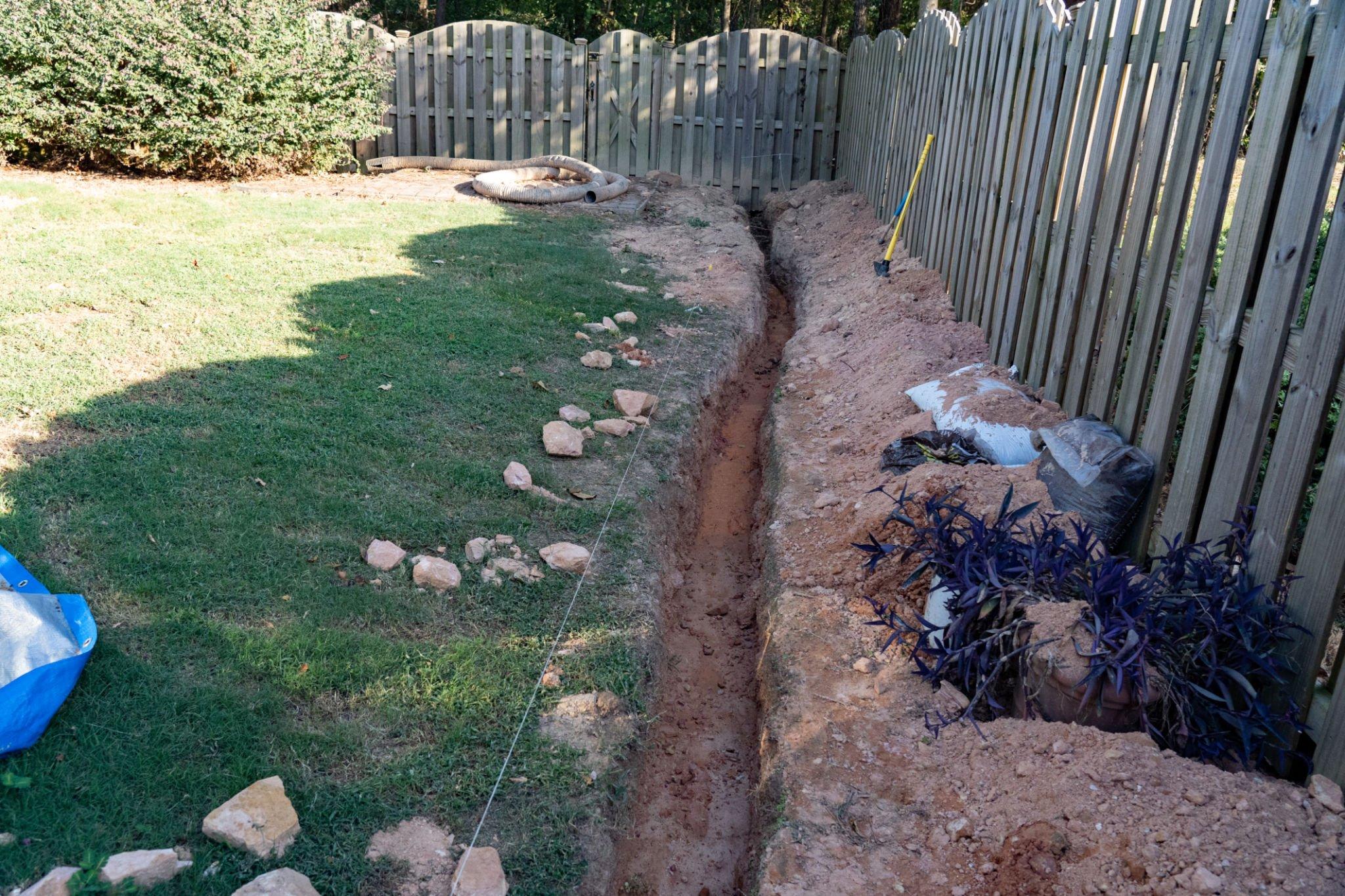 Digging a drainage path in backyard.